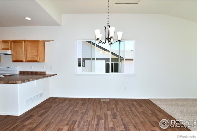 kitchen with stove, lofted ceiling, dark wood-type flooring, decorative light fixtures, and a chandelier
