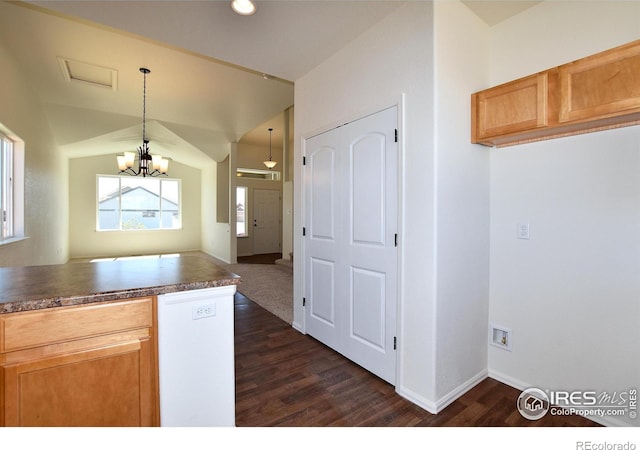 kitchen with kitchen peninsula, dark wood-type flooring, an inviting chandelier, dishwasher, and hanging light fixtures