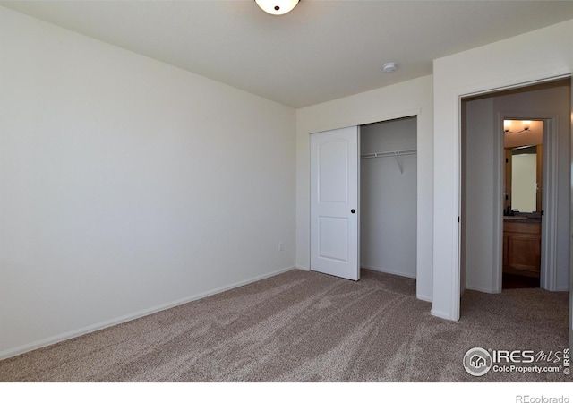 unfurnished bedroom featuring carpet floors and a closet