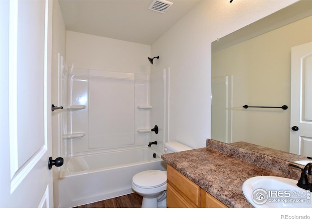 full bathroom with shower / tub combination, vanity, wood-type flooring, and toilet