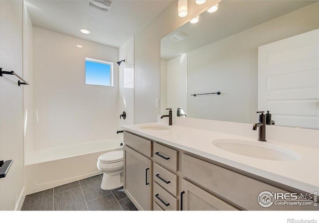 full bathroom featuring vanity, tile patterned floors,  shower combination, and toilet