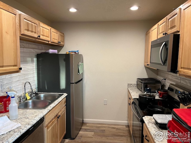 kitchen with decorative backsplash, sink, stainless steel appliances, and dark hardwood / wood-style floors