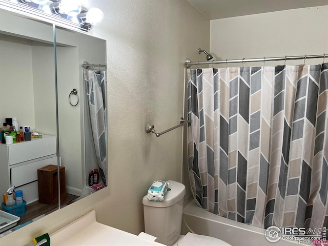 full bathroom with vanity, toilet, and shower / tub combo