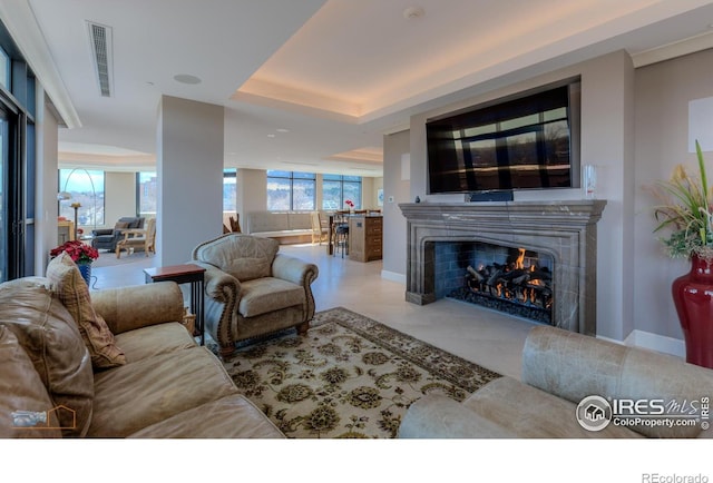 1077 Canyon Blvd # 403, Boulder, CO 80302 - living area with a warm lit fireplace, a raised ceiling, and baseboards