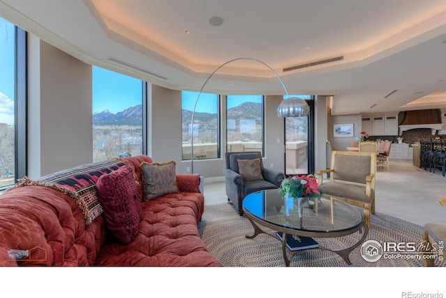1077 Canyon Blvd # 403, Boulder, CO 80302 - carpeted living room featuring a mountain view and a tray ceiling