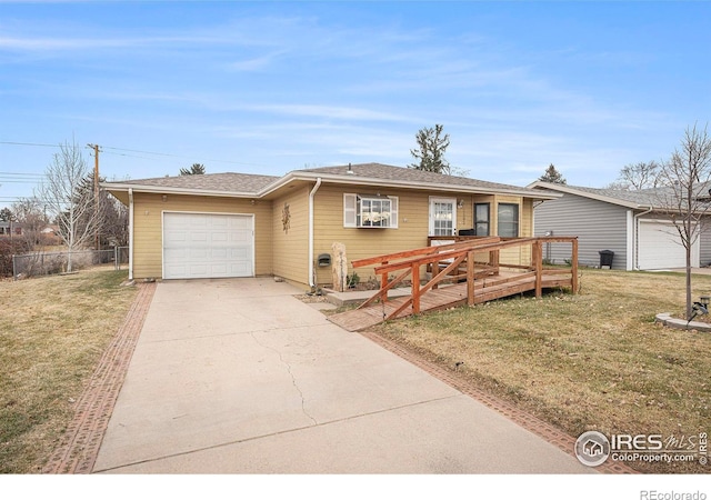 view of front of house featuring a garage, a front yard, and a deck