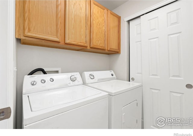 laundry area with cabinets and separate washer and dryer