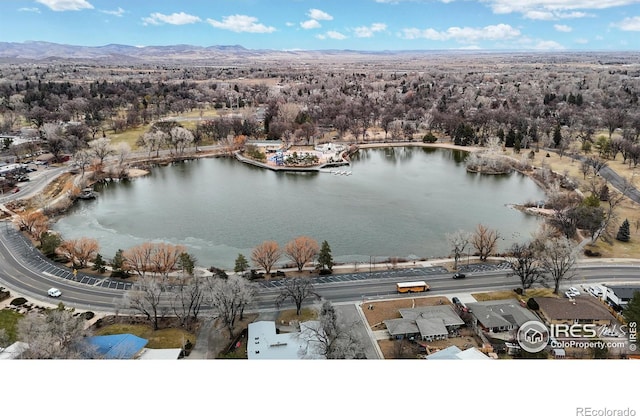 aerial view featuring a water and mountain view