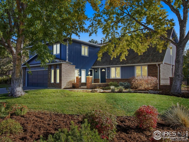 view of front of home featuring a garage and a front lawn