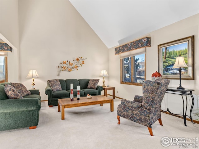 carpeted living room featuring high vaulted ceiling