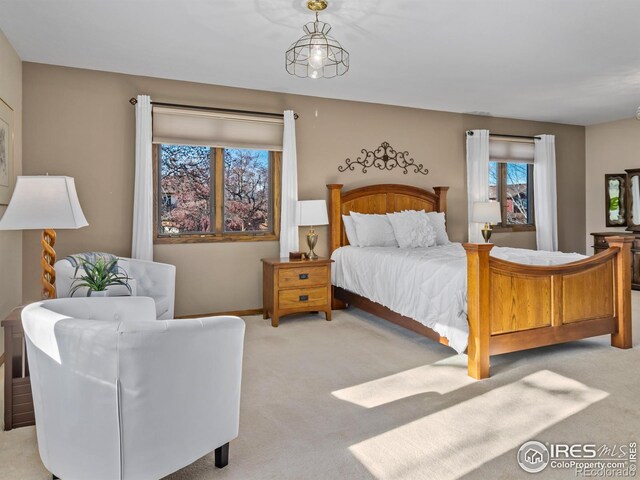 bedroom featuring light carpet