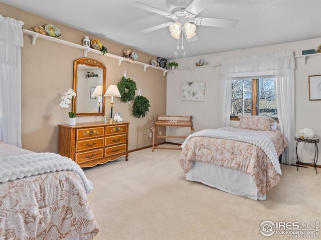 bedroom featuring ceiling fan and light colored carpet