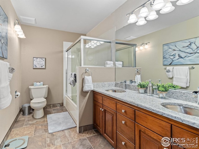 full bathroom featuring vanity, toilet, and enclosed tub / shower combo