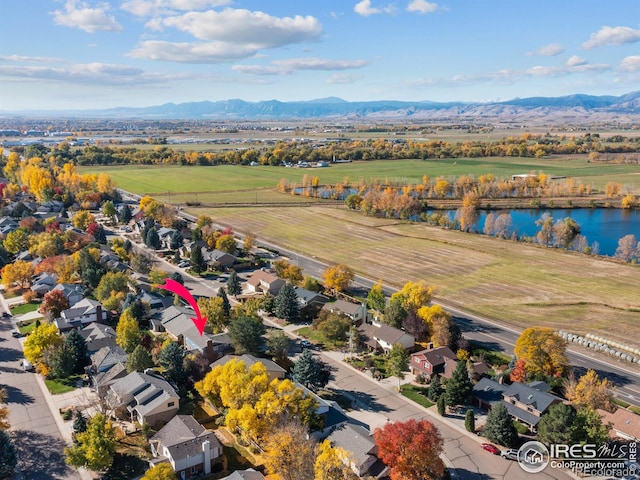 birds eye view of property with a water and mountain view