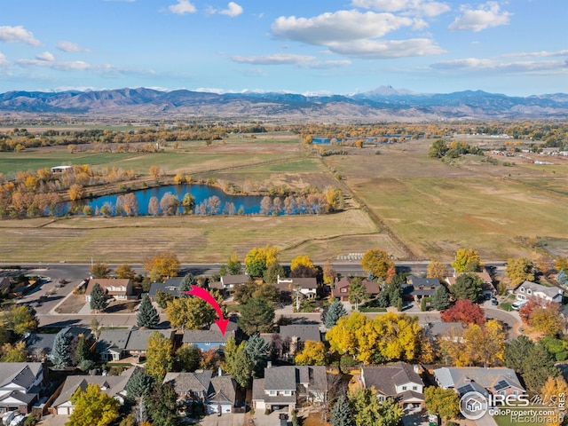 birds eye view of property with a water and mountain view