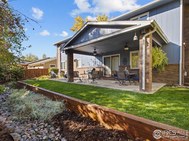 back of property featuring a yard, a patio, and ceiling fan