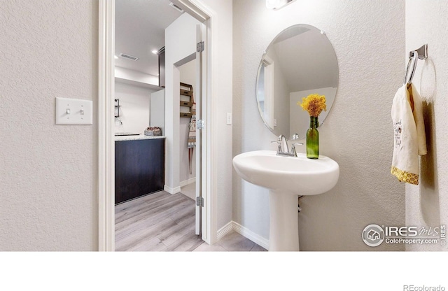 bathroom with hardwood / wood-style floors and sink