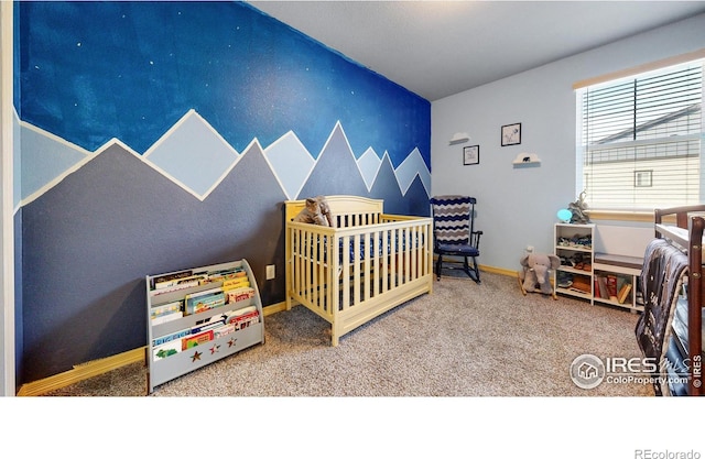 bedroom featuring carpet flooring and a nursery area