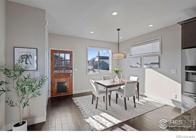 dining area with dark hardwood / wood-style flooring