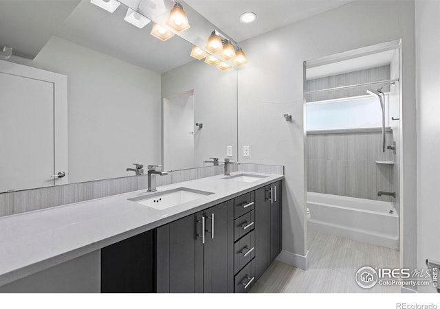 full bathroom with vanity, tiled shower / bath combo, and toilet