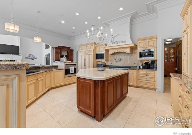 kitchen with decorative light fixtures, a center island, black microwave, oven, and decorative backsplash