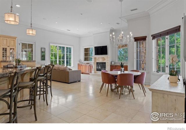 dining area with crown molding, a high end fireplace, and light tile patterned flooring