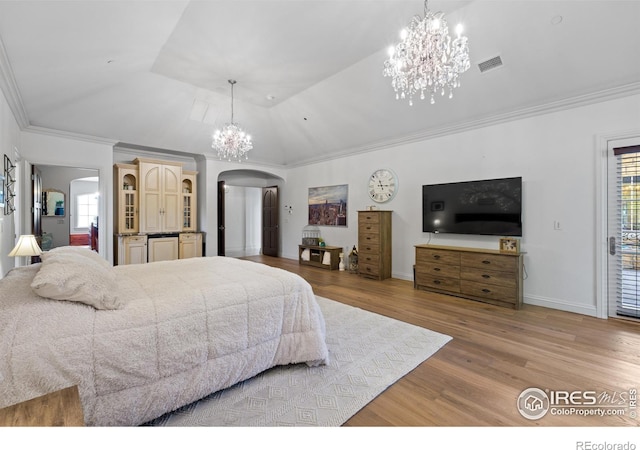 bedroom with crown molding, light wood-type flooring, and a chandelier