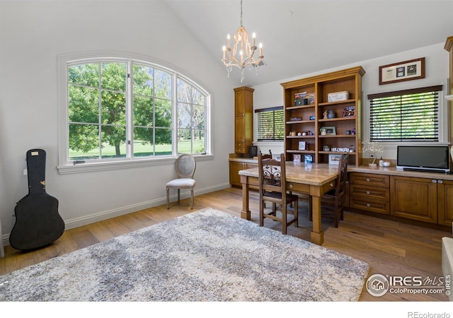 office with an inviting chandelier, hardwood / wood-style flooring, and vaulted ceiling