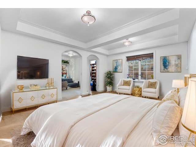 bedroom with a raised ceiling and ornamental molding