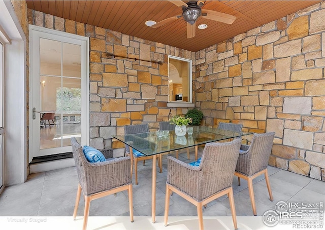 tiled dining space with wooden ceiling and ceiling fan