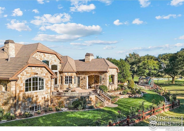 view of front of property featuring a front lawn and a patio