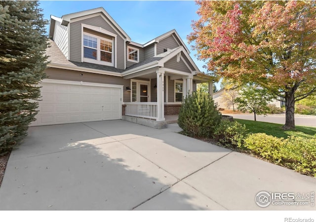 craftsman-style home featuring covered porch and a garage