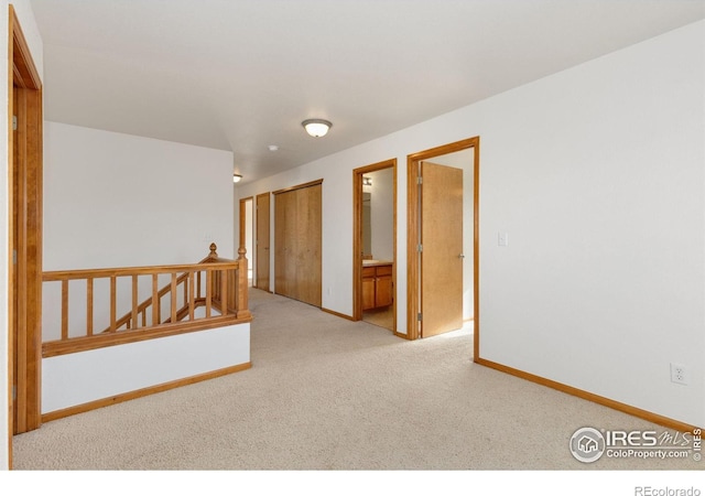 spare room with light colored carpet