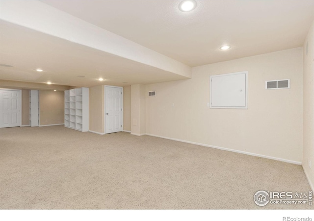 basement featuring light colored carpet