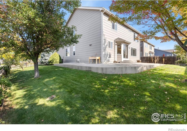 view of side of property with a yard and a patio