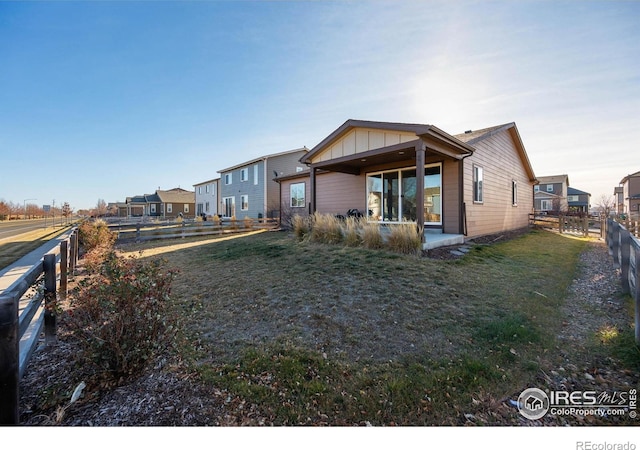 rear view of house featuring a yard