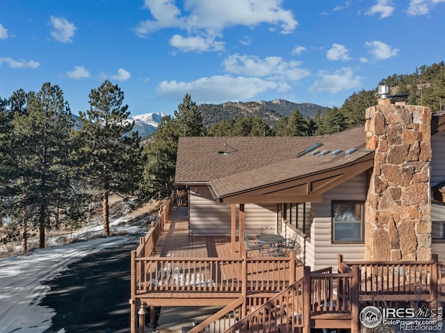 rear view of property with a deck with mountain view