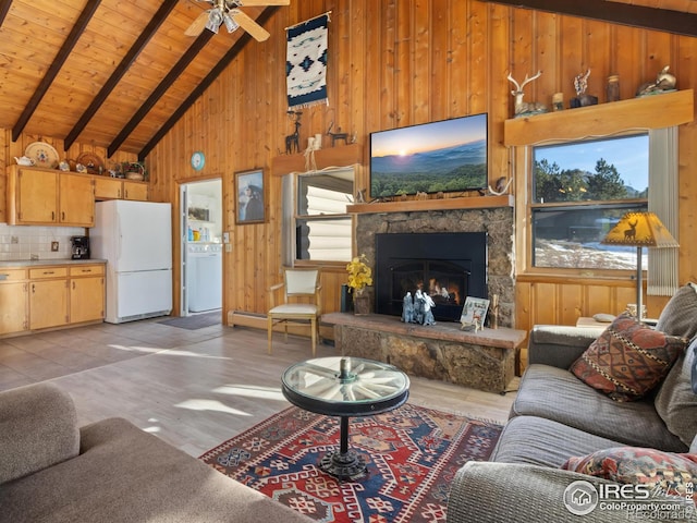 living room with high vaulted ceiling, beamed ceiling, wood walls, light hardwood / wood-style floors, and a fireplace