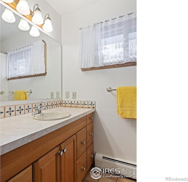 bathroom with vanity and a baseboard radiator