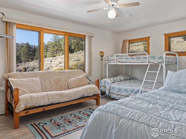 bedroom with light hardwood / wood-style floors and ceiling fan