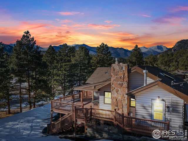 view of front of house with a deck with mountain view