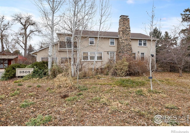 back of property featuring a balcony