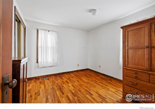 unfurnished bedroom with light wood-type flooring