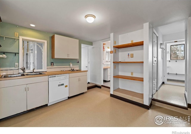 kitchen with white cabinetry, sink, and white dishwasher