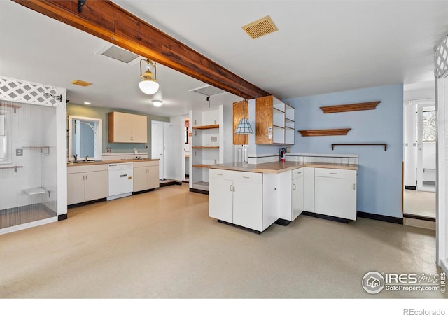 kitchen with kitchen peninsula, white dishwasher, sink, decorative light fixtures, and white cabinetry