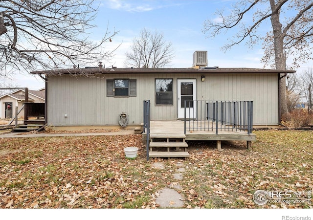 rear view of house featuring central AC unit and a deck