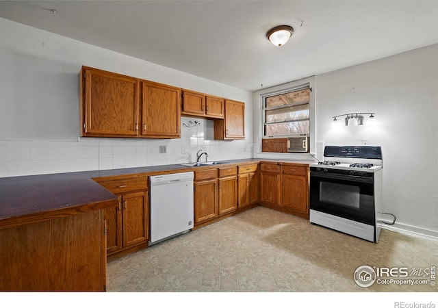 kitchen with backsplash, white appliances, and sink