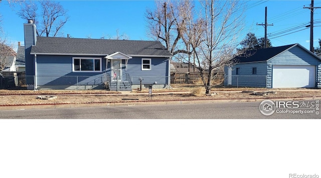 ranch-style home with an outbuilding and a garage