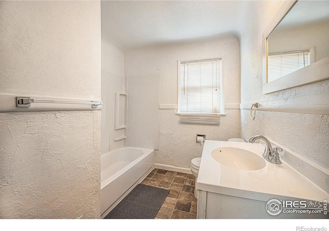 full bathroom with vanity, tub / shower combination, and toilet