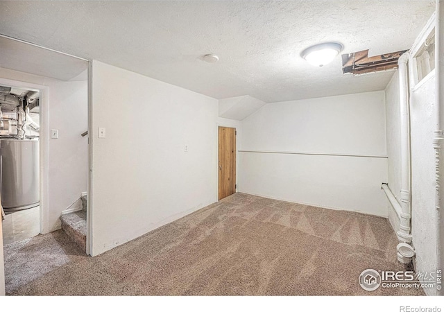 unfurnished room with a textured ceiling, carpet floors, and vaulted ceiling